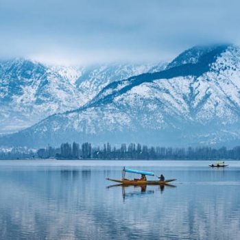 A view of Dal Lake in winter, and the beautiful mountain range in the background in the city of Srinagar, Kashmir, India.